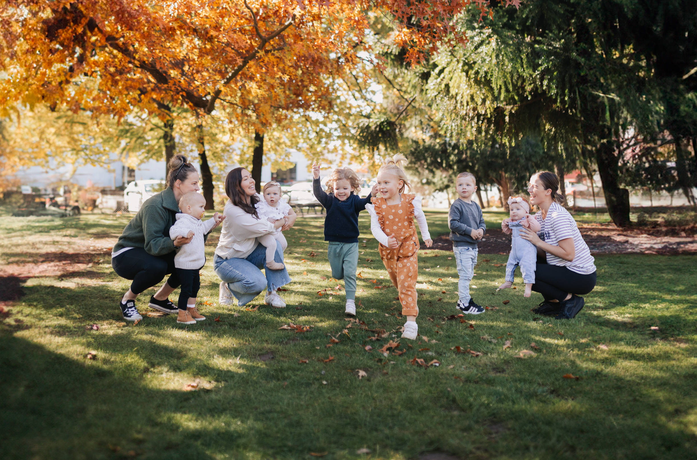 mums and children playing in autumn